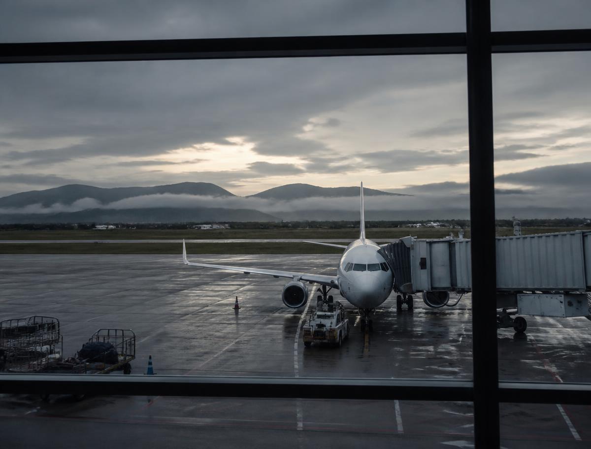 Aircraft at a Scottish airport gate on a grey early morning